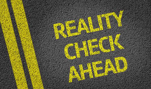 Reality Check Ahead written on the road