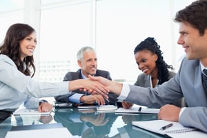 Young businesswoman and a co-worker shaking hands during a meeting